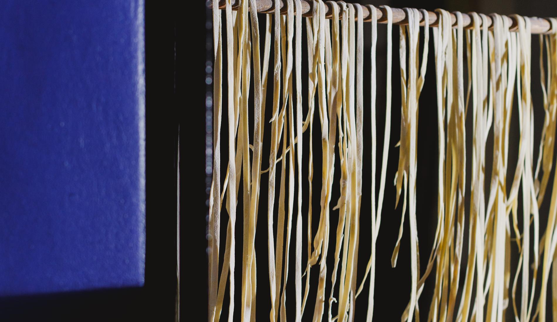 Fresh pasta drying in the window by candlelight
